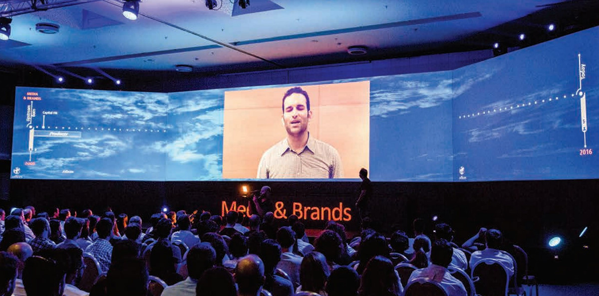 Upstream event — packed hall with wraparound LED
